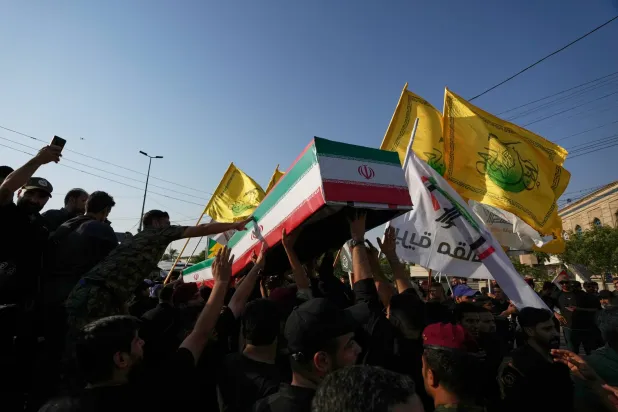  Mourners carry the coffin of an Iranian adviser draped in the Iranian flag during a group funeral for Iranian advisers and Popular Mobilization Forces fighters killed in airstrikes on bases belonging to Iraq's PMF in Mosul, Iraq, Wednesday, July 29, 2026. (AP) 