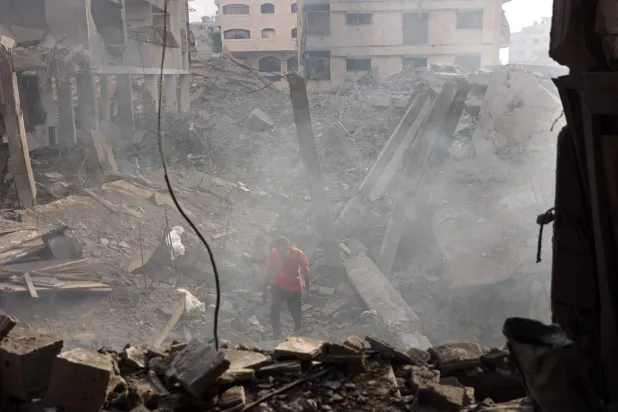 A Palestinian man looks for his belongings amid the debris of a destroyed building following an Israeli strike at the Al-Jalaa street in Gaza City on July 24, 2026. (AFP)