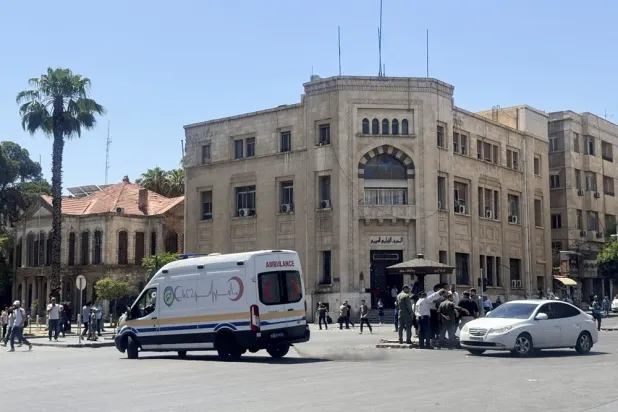 An ambulance drives past the site where explosive devices blew up near a hotel where French President Emmanuel Macron was meant to be staying, in Damascus, Syria, July 7, 2026. (Reuters) 