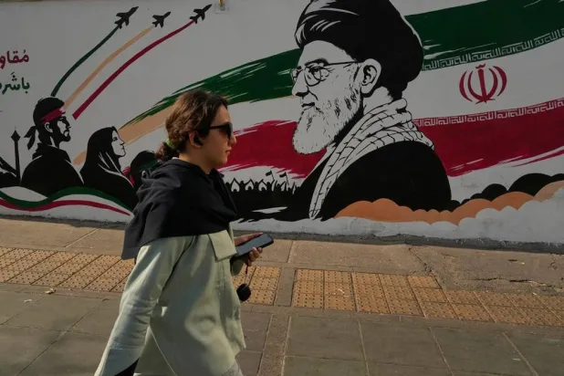  A woman walks past a mural depicting a portrait of the late Iranian Supreme Leader tollah Ali Khamenei, who was killed in the US and Israel strike on Feb. 28, at Azadi (Freedom) street in Tehran, Iran, Wednesday, July 29, 2026. (AP) 