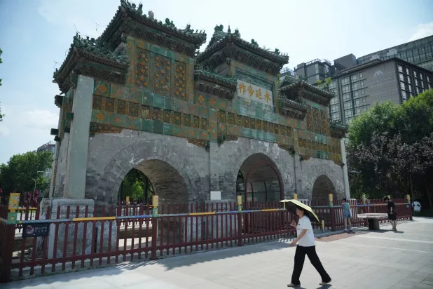  A Chinese woman uses an umbrella to shield herself from the sun, in Beijing, China, Saturday, Aug. 1, 2026. (AP) 