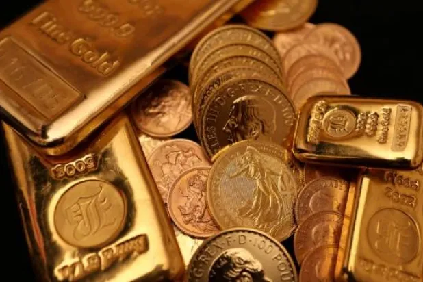 British gold Sovereign bars and coins are displayed at Baird & Co.'s headquarters in Hatton Garden, London (Reuters)