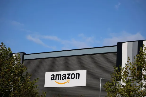 The Amazon logo outside an Amazon warehouse in Manchester, Britain, October 28, 2025. (Reuters)
