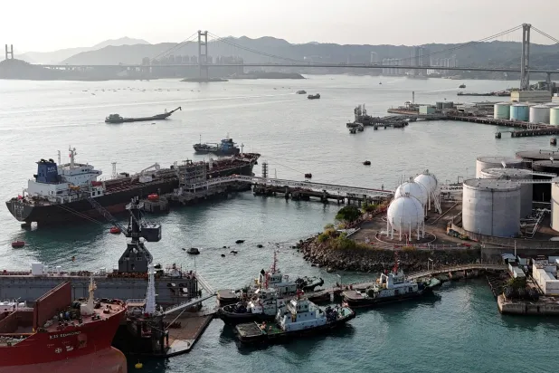 A drone view shows a Chinese-flagged oil tanker moored at an oil terminal at Tsing Yi port, with Tsing Ma bridge in the background, in Hong Kong, China March 19, 2026. (Reuters)