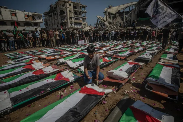 Palestinians gather during a mass funeral for 112 members of the Abu Sharia and Al-Hasayna families in the eastern Gaza City, 04 August 2026. (EPA)