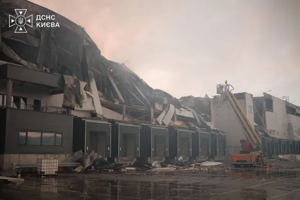 This handout photograph taken and released by Ukrainian State Emergency Service on August 5, 2026 shows rescuers working outside a warehouse premises damaged following massive Russian ballistic missile and drones strikes in the Ukrainian capital of Kyiv. (Photo by Handout / Ukrainian State Emergency Service / AFP)