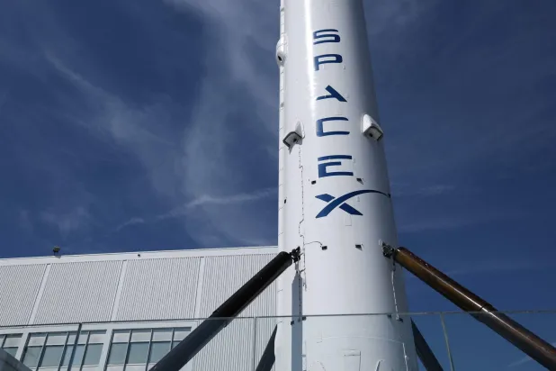 (FILES) A SpaceX Falcon 9 rocket is displayed outside a Space Exploration Technologies Corp. facility in Hawthorne, California on March 26, 2026. (Photo by Patrick T. Fallon / AFP)