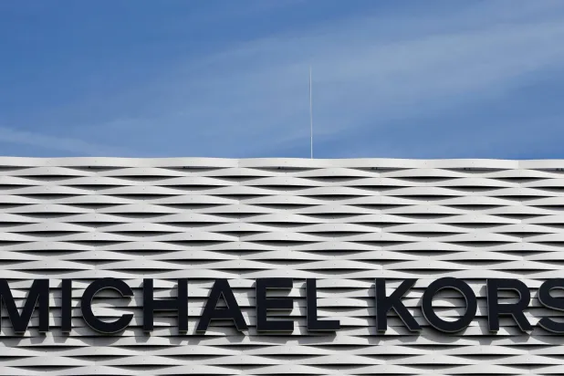 The logo of Michael Kors is seen on an outlet store in Metzingen, Germany, June 16, 2017. (Reuters)