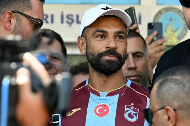 محمد صلاح لدى وصوله إلى مطار أتاتورك في إسطنبول لإتمام انتقاله إلى طرابزون سبور (أ.ف.ب)
