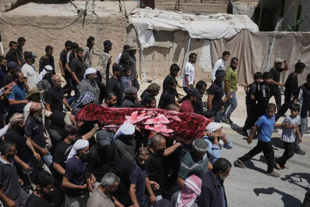 FILE -Mourners carry the body of Palestinian activist Awdah Al Hathaleen during his funeral in the West Bank Bedouin village of Umm al-Khair, Aug. 7, 2025. (AP Photo/Mahmoud Illean, File)