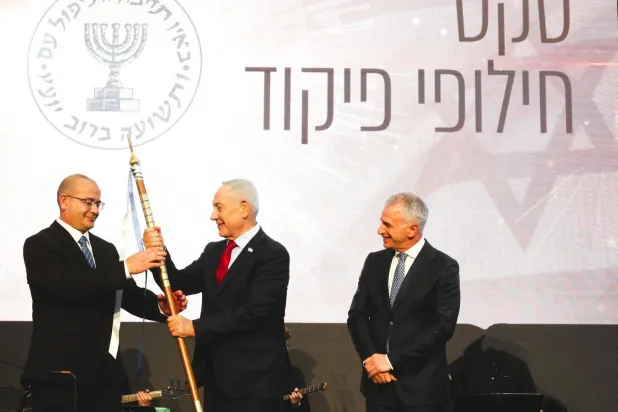 The new head of Israel's Mossad, Roman Gofman (left), receives a symbolic insignia during his inauguration as agency chief from Prime Minister Benjamin Netanyahu, with outgoing head David Barnea in attendance (X)