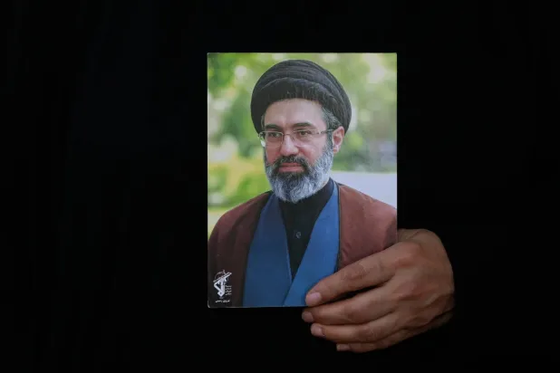 An Iranian woman holds a poster of the Supreme Leader Mojtaba Khamenei as she attends religious rituals in Tehran, Iran, Tuesday, Aug. 4, 2026. (AP) 