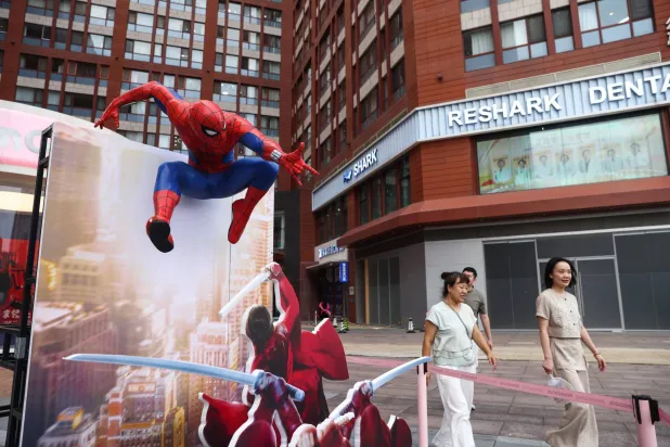 People walk past an advertisment display for the movie 'Spider-Man: Brand New Day' on a commercial street in Beijing, China, China, 08 August 2026. EPA/WU HAO