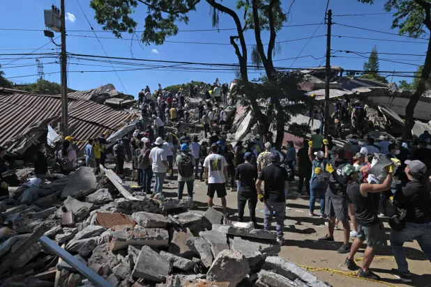 Rescuers look for survivors amid the rubble of a collapsed building after an earthquake in Cali, Colombia on August 10, 2026. (AFP)