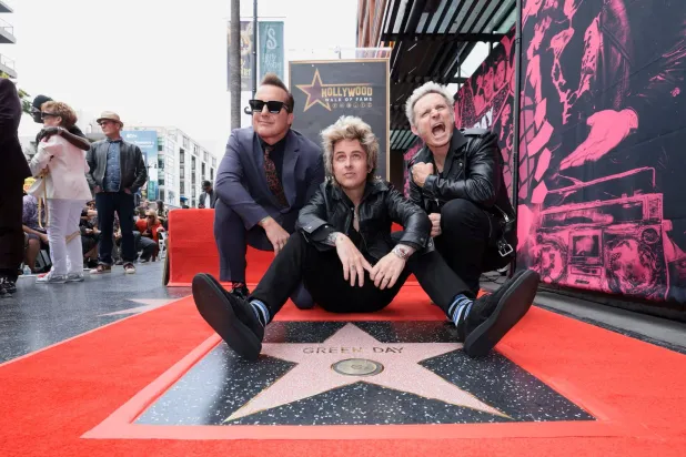 Billie Joe Armstrong, Mike Dirnt and Tre Cool from rock band Green Day pose on the day they unveil their star on the Hollywood Walk of Fame in Los Angeles, California, May 1, 2025. (Reuters)