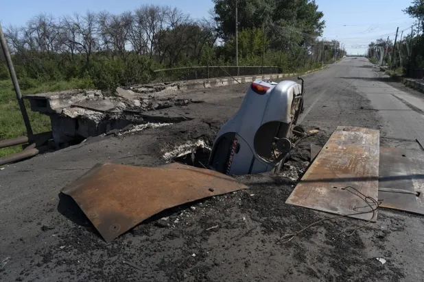 A handout picture made available by the press service of the 93rd Separate Mechanized Brigade of the Ukrainian Armed Forces shows a civilian car in a crater on a bridge in the frontline city of Druzhkivka in the Donetsk region, Ukraine, 11 August 2026, amid the ongoing Russian invasion. (EPA/Press service of the 93rd Separate Mechanized Brigade/Handout)