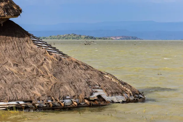 A crocodile perches on the roof of what was the conference hall of a tourist lodge now completely inundated in the rising waters of the Lake Bogoria in Marigat sub-county, Baringo county on July 27, 2026. (AFP)