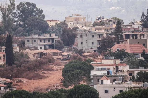 A photograph taken from the southern Lebanese village of Zawtar al-Gharbiyeh shows Israeli tanks as they maneuver in the nearby village of Zawtar al-Sharkiyeh on August 8, 2026. (AFP)