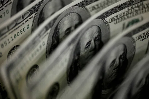 A picture illustration shows US 100 dollar bank notes taken in Tokyo August 2, 2011. (Reuters)