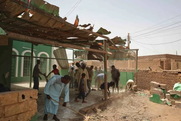 People clear debris from a mosque that residents said was damaged in a drone strike in Khartoum, Sudan, Wednesday, Aug. 12, 2026. (AP)