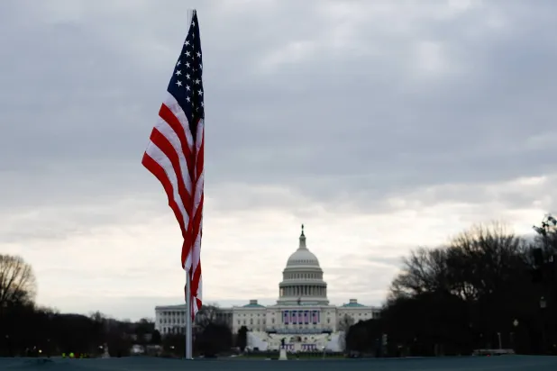 The American flag flies in the National Mall near the Capitol building in Washington (Reuters)