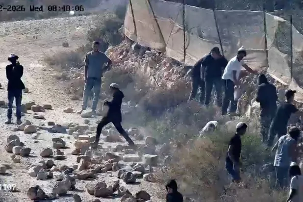 CCTV footage shows, as witnesses say, Jewish settlers throwing rocks on the road in Qusra, in the Israeli-occupied West Bank, August 12, 2026 in this screengrab taken from a handout video- REUTERS 