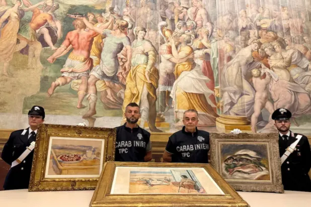 Carabinieri officers pose with three paintings by Paul Cezanne, Henri Matisse and Pierre-Auguste Renoir recovered after they were stolen from the Magnani Rocca Foundation in Mamiano, Italy, in this handout image released on August 14, 2026. Carabinieri/Handout via REUTERS 