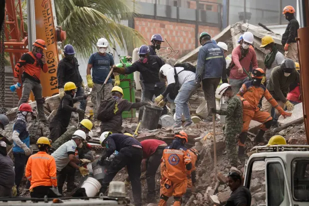 Volunteers participate with rescue teams in search and rescue operations after the earthquake that struck Colombia (Reuters)