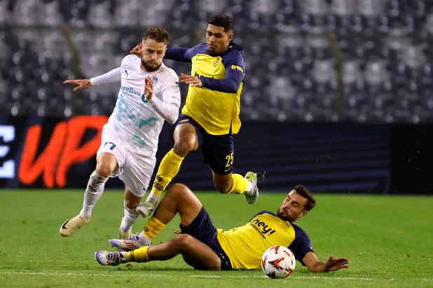 FILE - Union SG's Charles Vanhoutte, right, and Union SG's Anan Khalaili, center, fight for the ball against Glimt's Philip Zinckernagel during the Europa League opening phase soccer match between Union SG and Bodo/Glimt at the King Baudouin stadium in Brussels, on Oct. 3, 2024. (AP Photo/Geert Vanden Wijngaert, File)