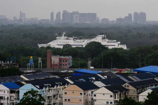 A ship that ferries passengers and vehicles during a 22-hour journey between Bangkok and the southern Thai island of Koh Samui, sails along the Chao Praya River in Bangkok on August 12, 2026. (Photo by ANTHONY WALLACE / AFP)