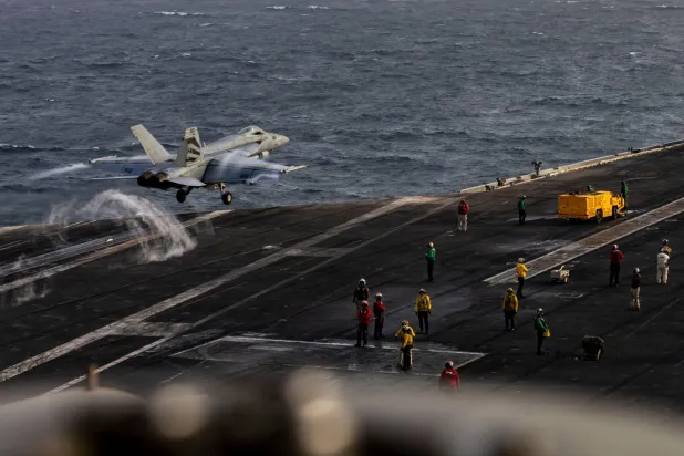 This US Navy handout photograph released on August 4, 2026, by US Central Command Public Affairs shows an F/A-18E Super Hornet launching from the flight deck of Nimitz-class aircraft carrier USS Abraham Lincoln on July 31, 2026. (AFP / US Navy / Navcent Public Affairs)