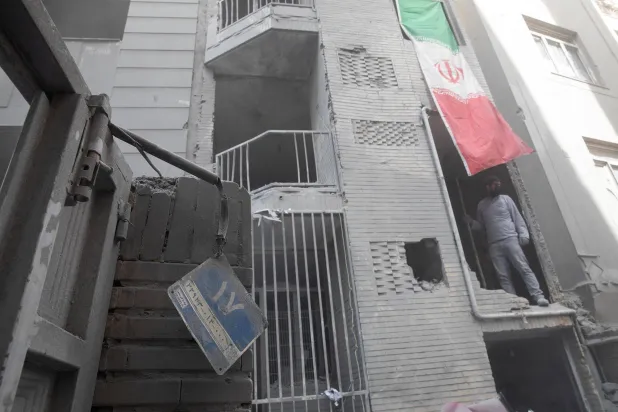 رجل داخل مبنى متضرر بضربة في طهران خلال الحرب الأميركية - الإسرائيلية مع إيران بعدسة المصورة يلدا معيري المحكوم عليها بالسجن 15 عاماً (رويترز)