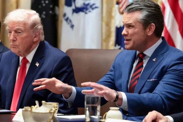 US President Donald Trump listens as Secretary of War Pete Hegseth speaks (Reuters)