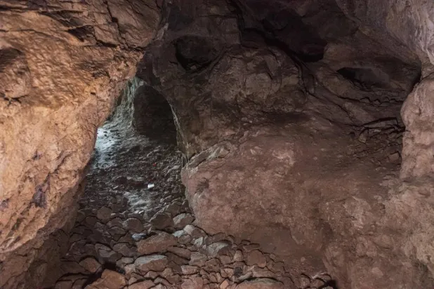 Access to the rock-strewn cave is not easy. Ahmet Ayberk Cimen / AFP
