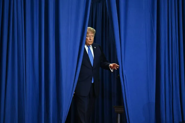US President Donald Trump arrives to deliver remarks at the Nassau County Police Academy Center for Training and Intelligence in Garden City, New York, on August 14, 2026. (Photo by Kent NISHIMURA / AFP)