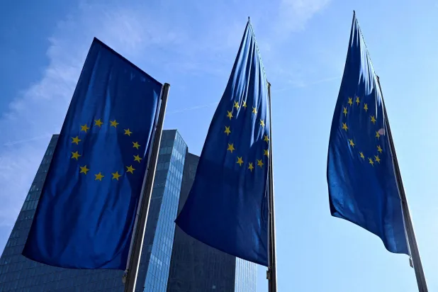 FILE PHOTO: European Union flags flutter outside the European Central Bank (ECB) headquarters in Frankfurt, Germany, March 19, 2026. REUTERS/Jana Rodenbusch/File Photo