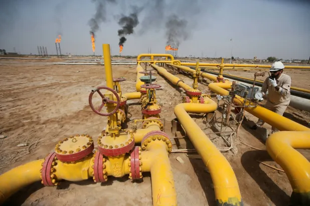 FILE PHOTO: A worker checks an oil pipeline at Nahr Bin Umar oil field, north of Basra, Iraq March 22, 2022. REUTERS/Essam Al-Sudani/File Photo
