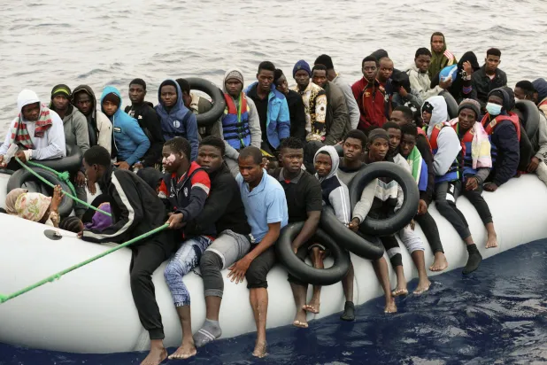 FILE - Migrants are brought to shore after being intercepted by the Libyan coast guard on the Mediterranean Sea, in Garaboli Libya, on Oct. 18, 2021. (AP Photo/Yousef Murad, File)