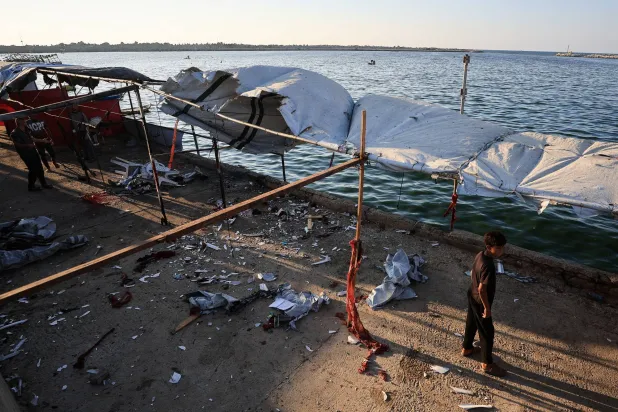 A Palestinian inspects the site of an Israeli strike on a cafe, at the seaport of Gaza City, August 18, 2026. (Reuters)