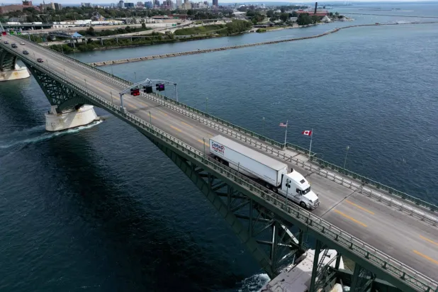 This aerial view shows a Capital Southern Transportation, Inc. truck passing over the Peace Bridge between Canada and the US in Fort Erie, Ontario, on August 18, 2026. (AFP)