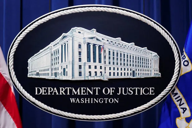 A U.S. Justice Department logo or seal showing Justice Department headquarters, known as "Main Justice," is seen behind the podium in the Department's headquarters briefing room before a news conference with the Attorney General in Washington, January 24, 2023. (Reuters)