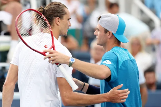 MASON, OHIO - AUGUST 19: Tommy Paul of the United States hugs Alexander Zverev of Germany after a match on day nine of the Cincinnati Open at Lindner Family Tennis Center on August 19, 2026 in Mason, Ohio. Emilee Chinn/Getty Images/AFP