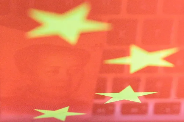 FILE PHOTO: A China yuan banknote featuring late Chinese chairman Mao Zedong and a computer keyboard are seen reflected on an image of Chinese flag in this illustration picture taken November 1, 2019.  REUTERS/Florence Lo/Illustration/File Photo