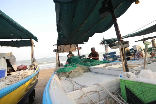 Fishermen check their nets and small boats on the seashore in the port city of Bandar Abbas, in southern Iran on August 10, 2026. (AFP)
