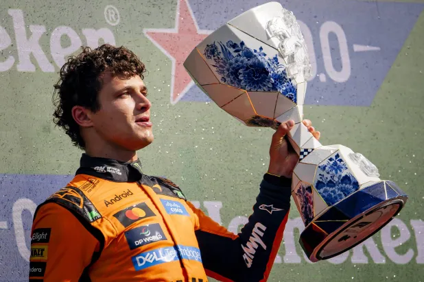 First placed McLaren driver Lando Norris of Britain celebrates with the trophy on the podium after the Formula 1 Dutch Grand Prix at the Circuit Zandvoort racetrack in Zandvoort, Netherlands, 23 August 2026.  EPA/Sem van der Wal