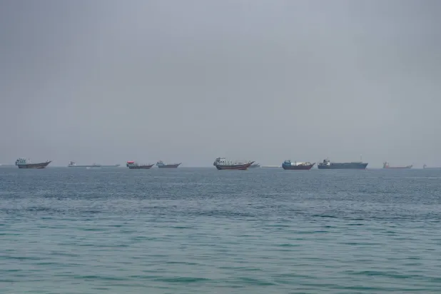 Vessels near the Strait of Hormuz, as seen from Musandam, Oman, August 24, 2026. REUTERS/Stringer