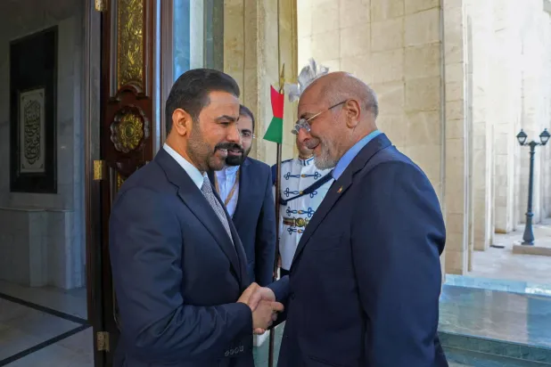 This handout photograph taken and released by the Iraq's Prime Minister Media Office on August 19, 2026 shows Iran's Parliament Speaker Mohammad Bagher Ghalibaf (R) shaking hands with Iraq's Prime Minister Ali al-Zaidi before their meeting in Baghdad. (Iraq's Prime Minister Media Office / AFP) 