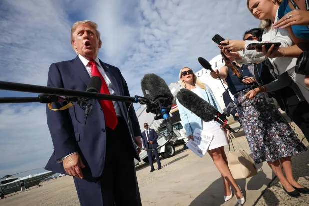 JOINT BASE ANDREWS, MARYLAND - AUGUST 21: US President Donald Trump speaks with reporters before boarding Air Force One on August 21, 2026 in Joint Base Andrews, Maryland. Win McNamee/Getty Images/AFP