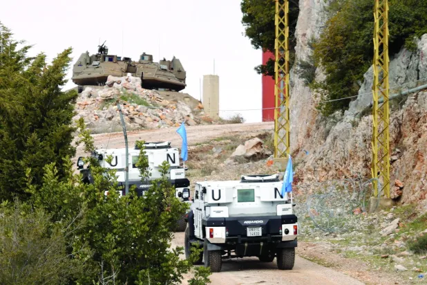 A photo taken from the southern Lebanese area of Marjeyoun, shows UNIFIL forces driving towards an Israeli army position in the southern Lebanese village of Kfar Shouba on February 15, 2025. (AFP)