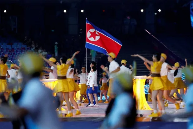 Asian Games - Hangzhou 2022 - Opening Ceremony - Hangzhou Olympic Sports Center Stadium, Hangzhou, China - September 23, 2023 Athletes from North Korea hold their national flag at the Opening Ceremony. (Reuters)